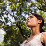 woman getting fresh air, meditating, outdoors