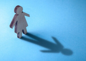 illustration of transgender identity; female icon seeing male icon shadow