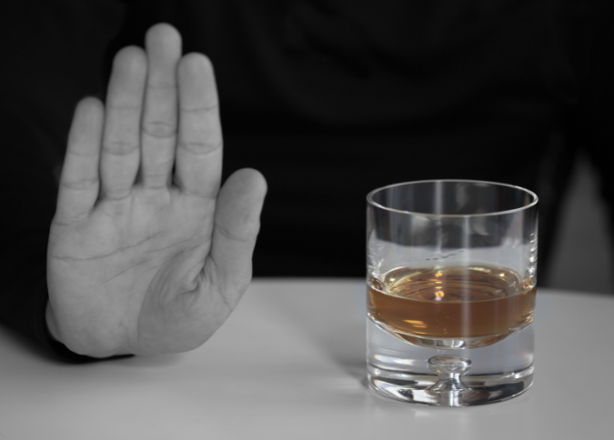 Rethinking Your Drinking - hand saying no to cocktail